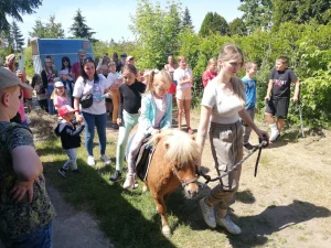 Dzień Dziecka 2023 na ROD im. 40-lecia WP - dzieci idące za kucykiem