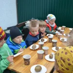 Wizyta przedszkola Bajka - dzieci z pieczonymi ziemniakami